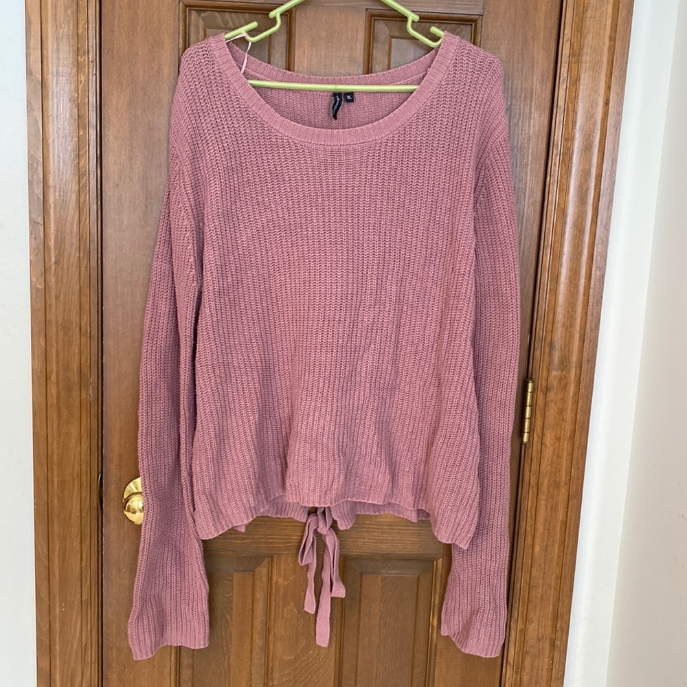 Oversized pink sweater with tie detail in back.
